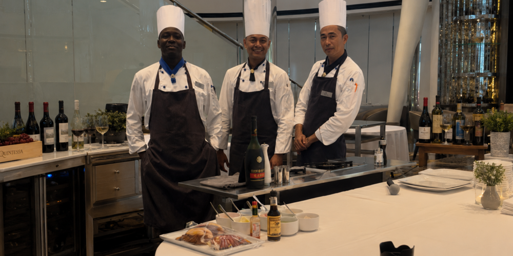 Private chefs plating a cooking class dinner for a small group