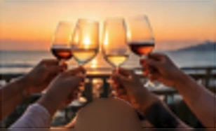 Guests raising glasses together at sunset