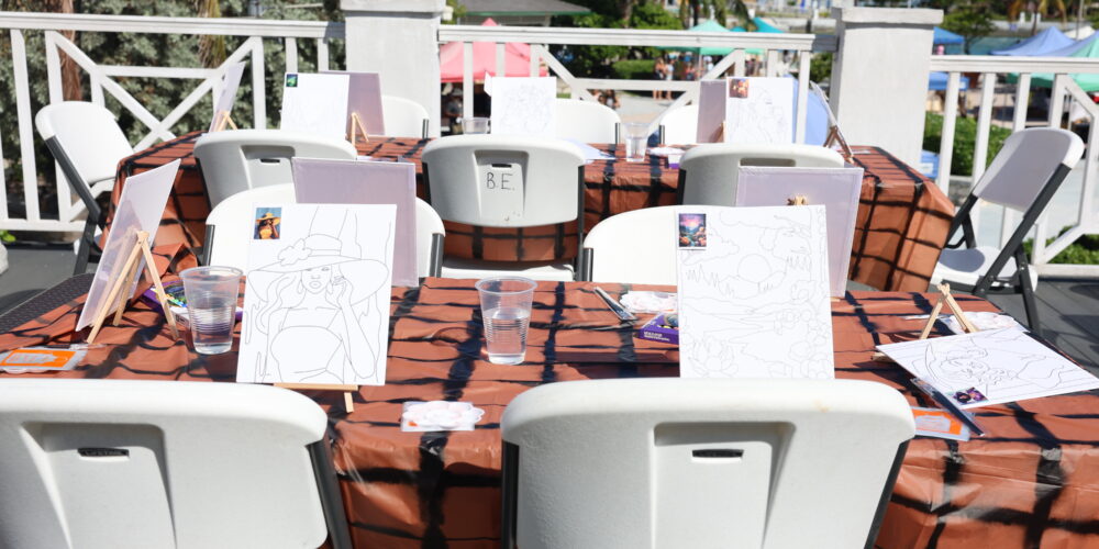 Members painting at easels in a hands-on art workshop