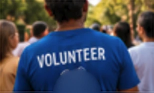 Volunteer in a blue T-shirt at a community gathering