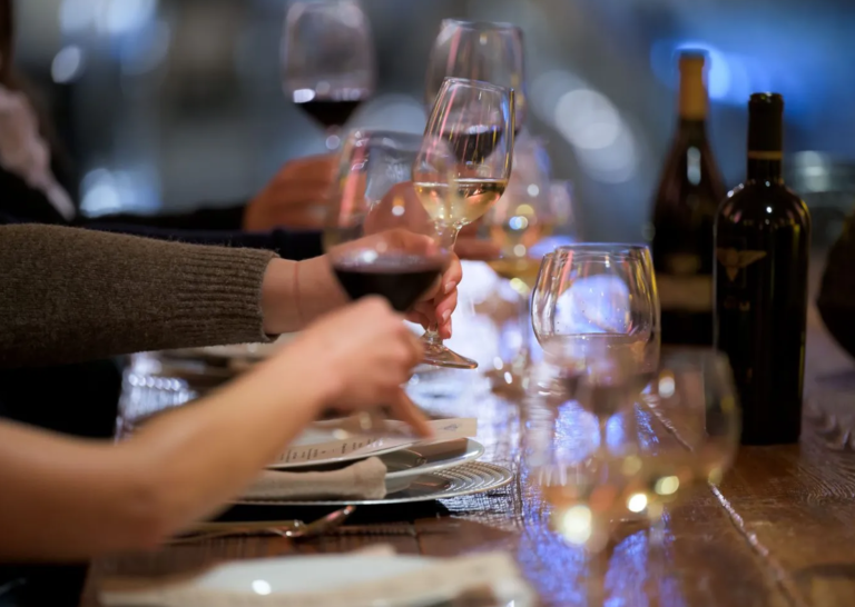 Clients and partners raising glasses in a toast at a private dinner