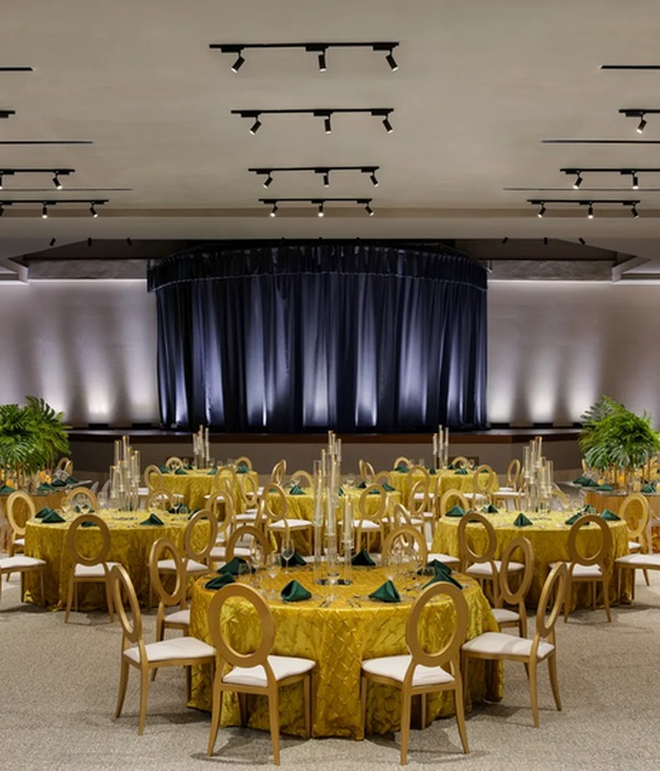 Banquet room set with gold-draped round tables for a private group dinner