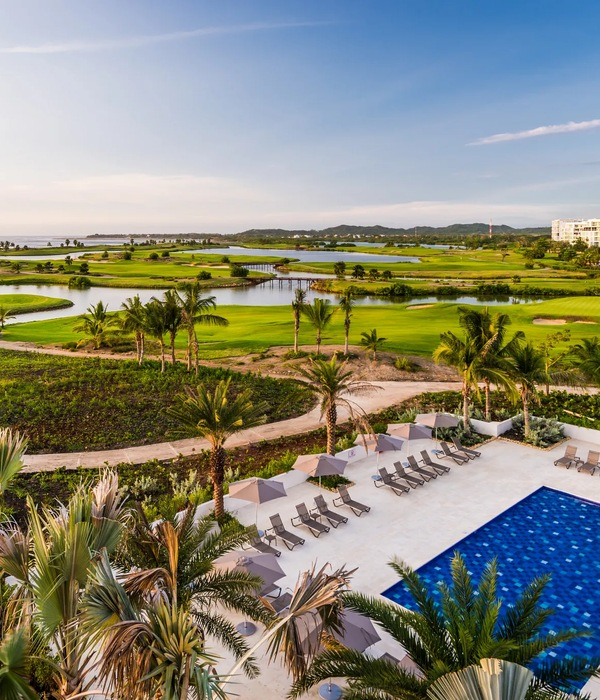 Resort grounds overlooking a golf course and lagoon at sunset