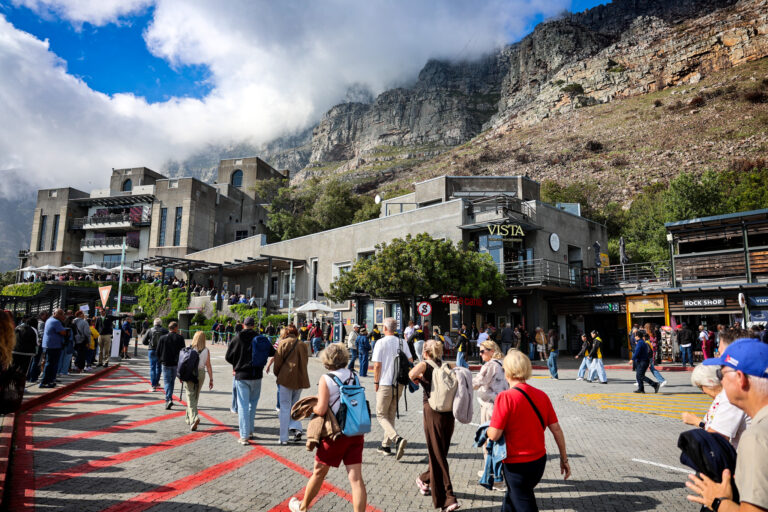 Travel group walking together at the base of Table Mountain in Cape Town