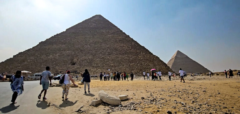 Large travel group touring the Great Pyramids of Giza in Egypt