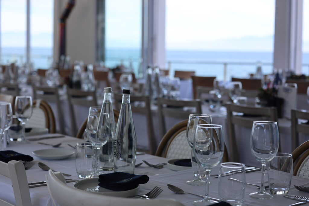 Exclusive dining experience with elegant table settings and ocean views
