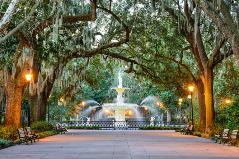 Forsyth Park fountain under live oaks in Savannah at dusk